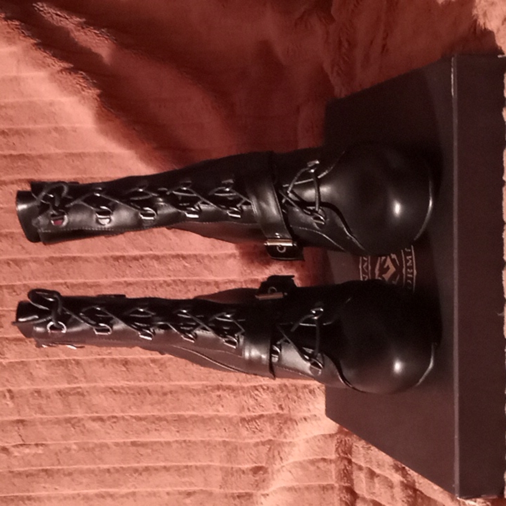 Genuine Leather. Brand new black pair of black boots with a 2 and 1/2 inch heal.